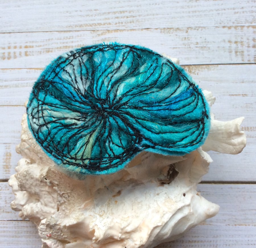 Embroidered needle felted nautilus shell brooch.