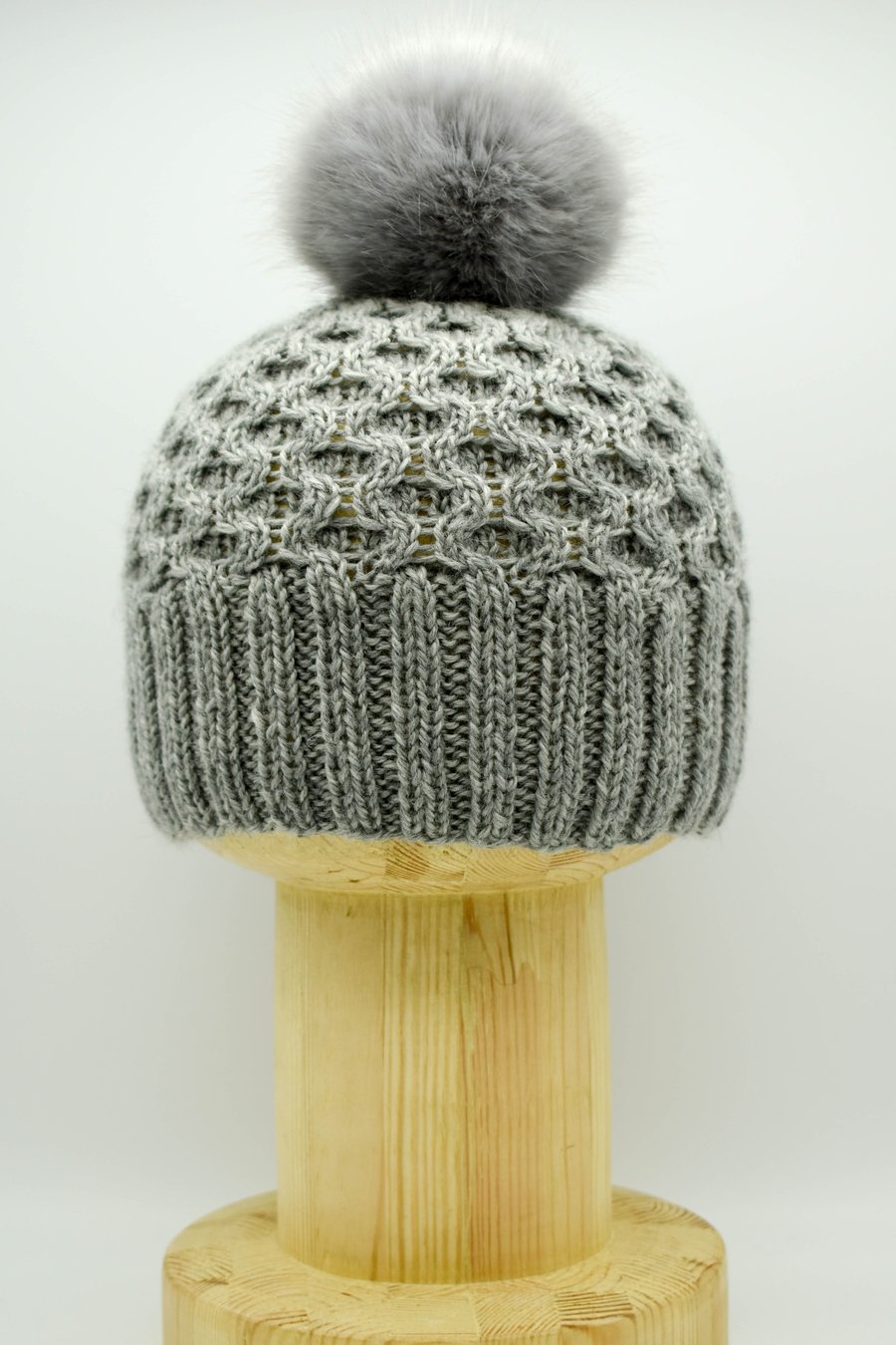 Hand Knitted "Honeycomb" faux fur pom-pom hat in grey