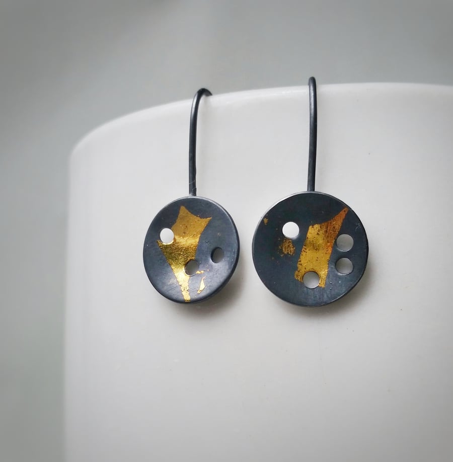 Textured Disc Silver and black Drop Earrings with little gold detail.