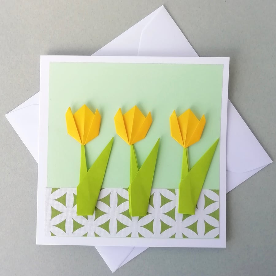 Yellow tulips on pale green greetings card