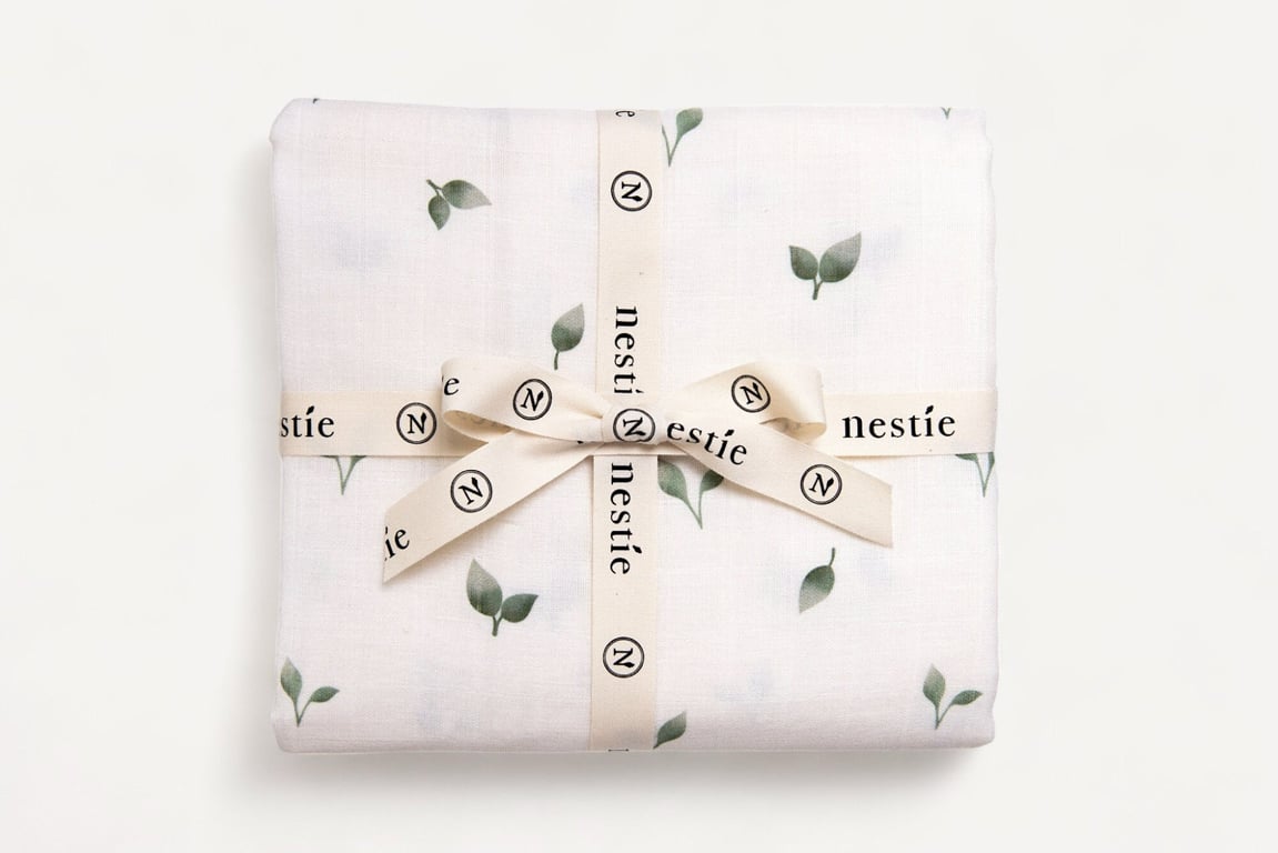 Two Layer Muslin Baby Blanket and Swaddle in our delicate Nestie Allotment Theme