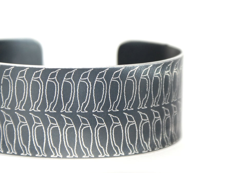 Geometric penguin print aluminium cuff dark grey