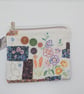 Zipped pouch with embroidery and buttons
