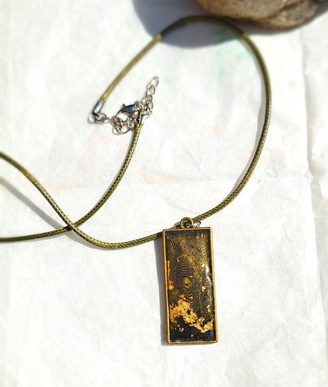 Rectangular pendant on a rope necklace, blue, black, gold, white
