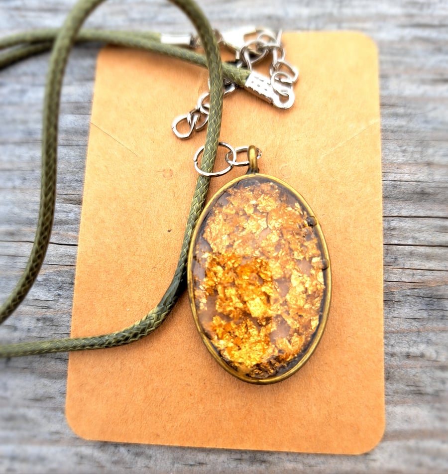 Gold flecked leaf resin pendant on a rope necklace