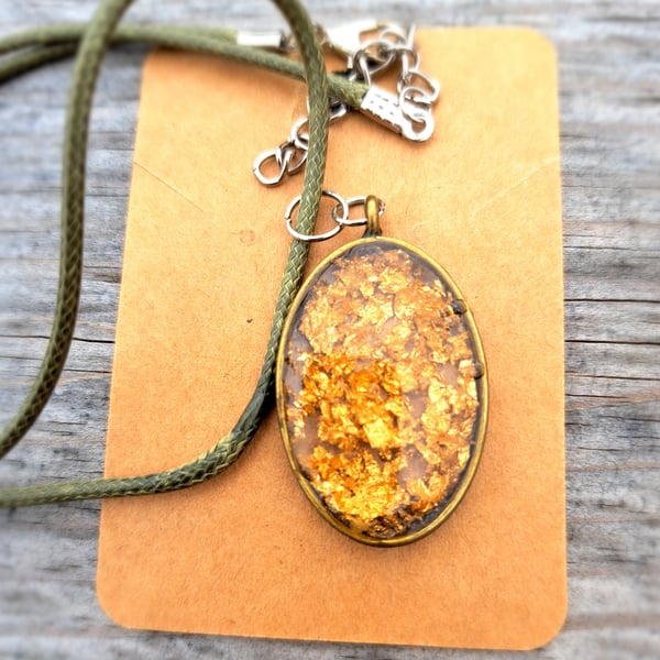 Gold flecked leaf resin pendant on a rope necklace