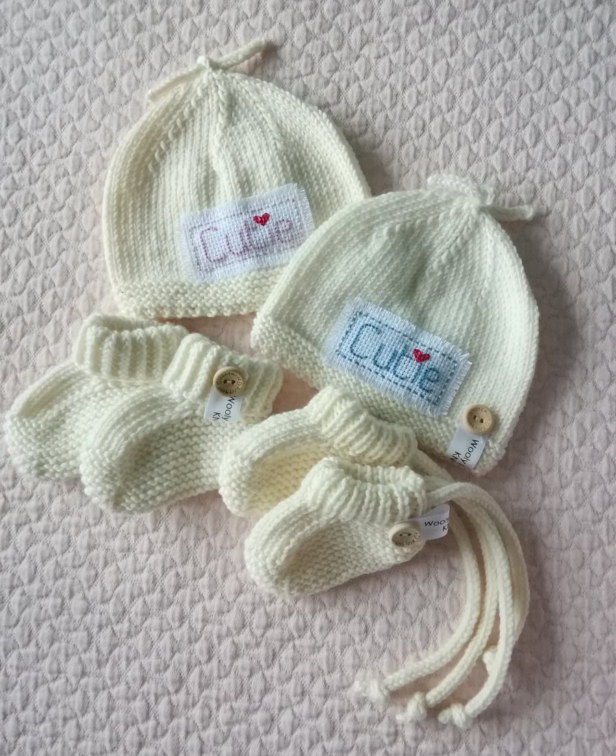 Hand knitted baby top knot hat and bootie set