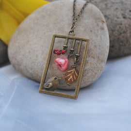 Bird with amber leaf and flower necklace