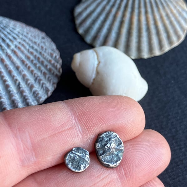 Mismatch pair of recycled oxidised silver stud earrings.