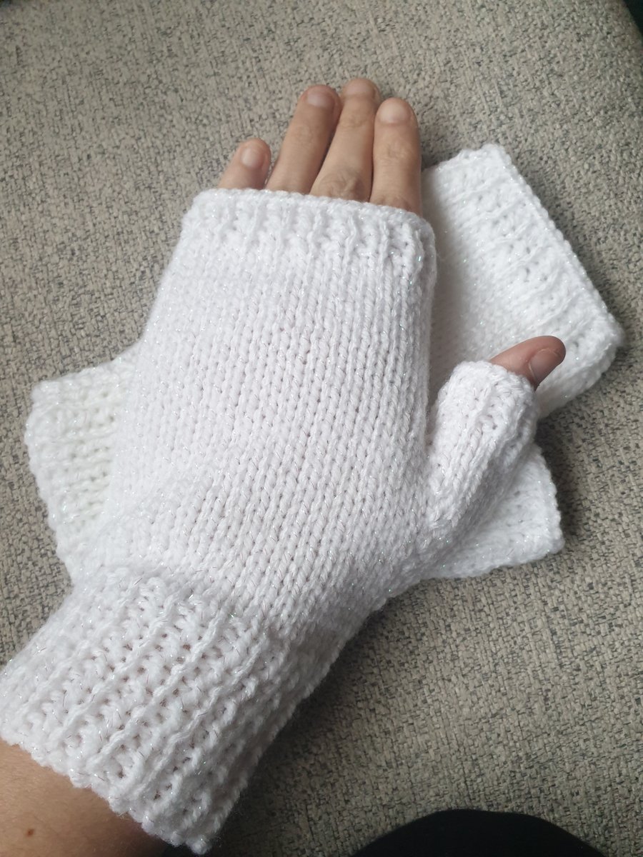 White knitted fingerless gloves.