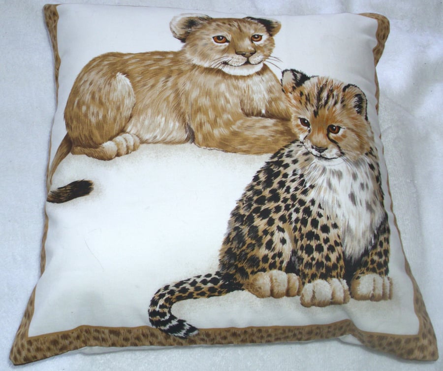 Adorable young Leopard cubs sitting waiting cushion