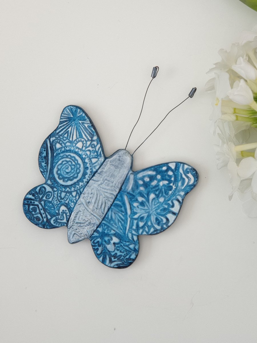   Pretty embossed clay butterfly fridge magnet