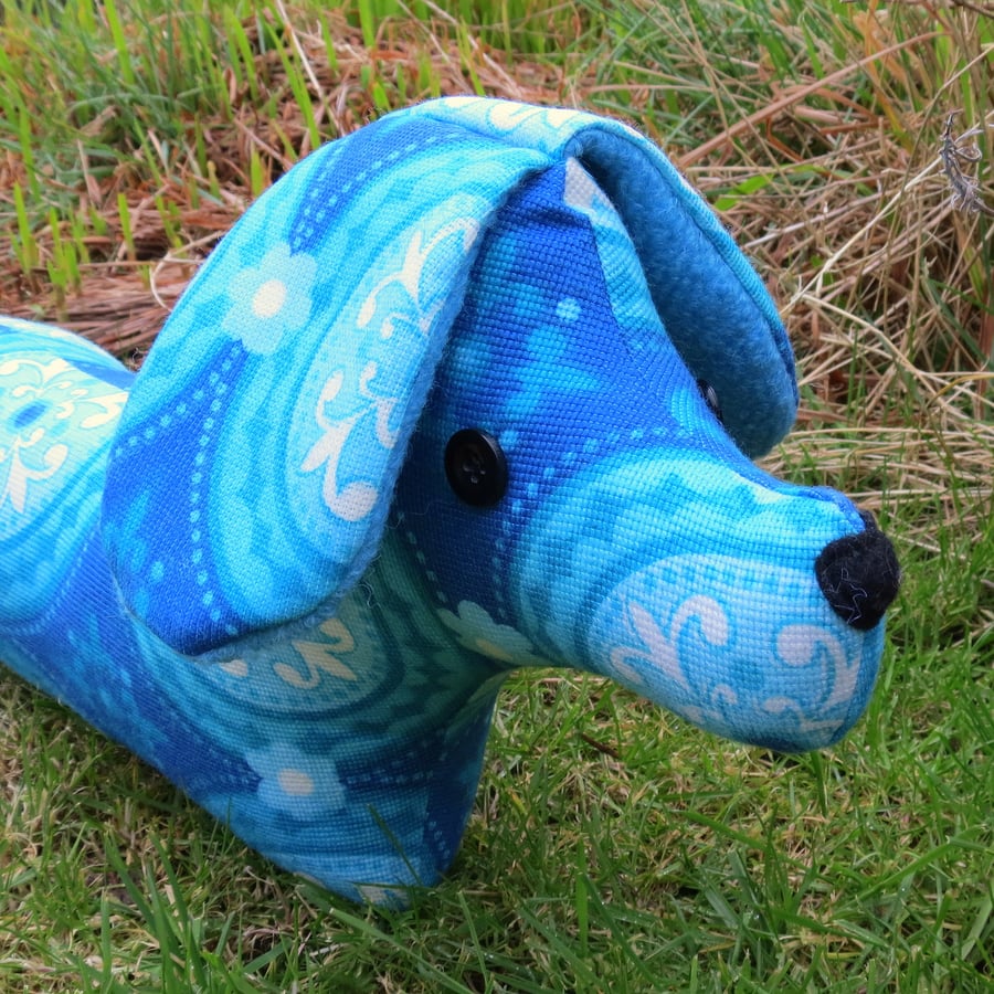 Daisy, a groovy retro dog draught excluder.