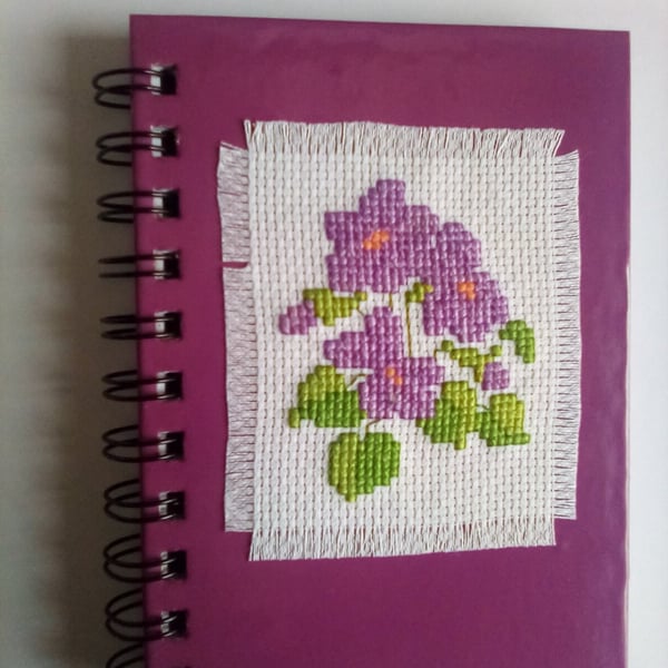 Violet hand stitched cross stitch floral notebook.