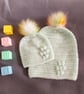 Matching ladies and baby green crocheted hats with detachable faux fur pompoms  - Image 1