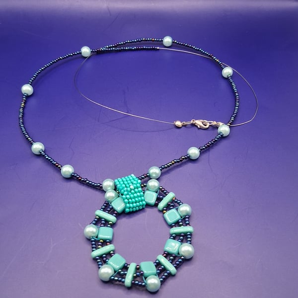 Handmade Beaded Necklace in Turquoise and Petrol Blue with Circular Pendant