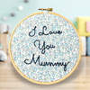 Hand embroidered wall hanging saying I love you mummy on ditsy blue fabric 