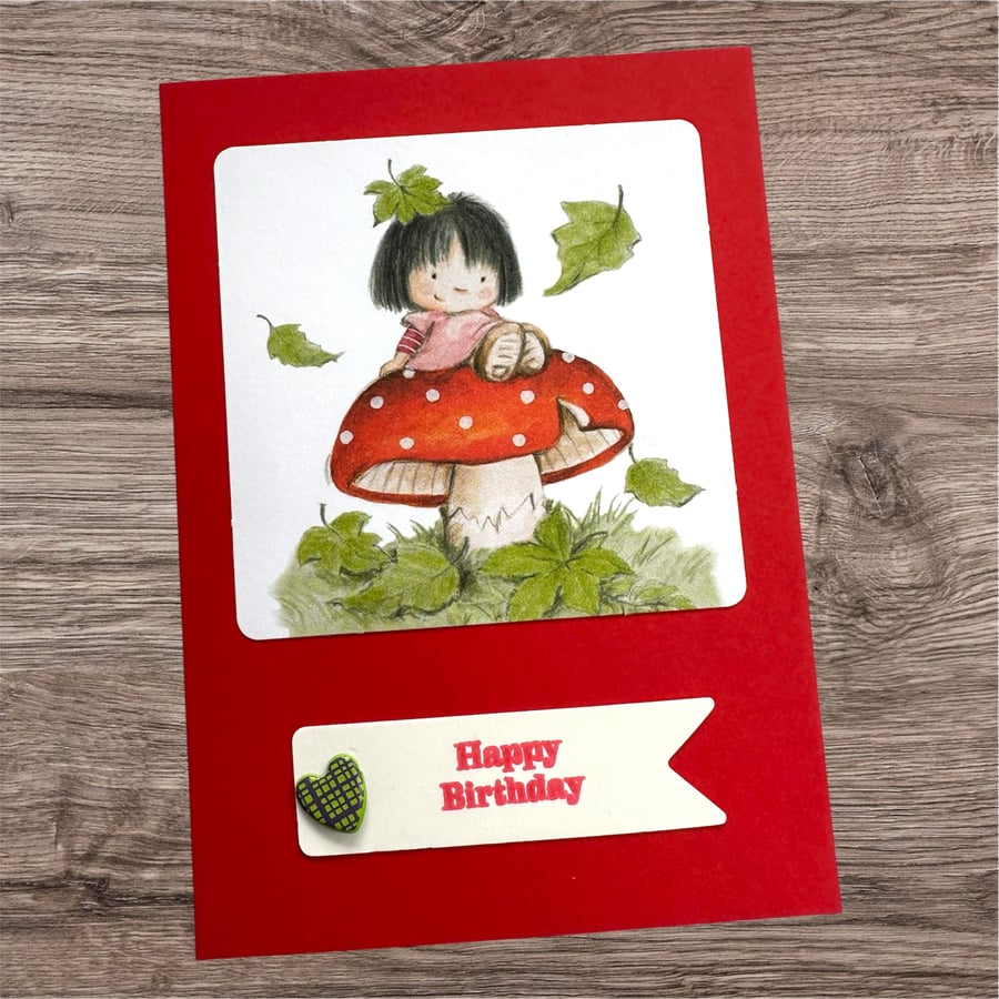 Happy birthday card for a girl. Cute girl sat on a toadstool. 