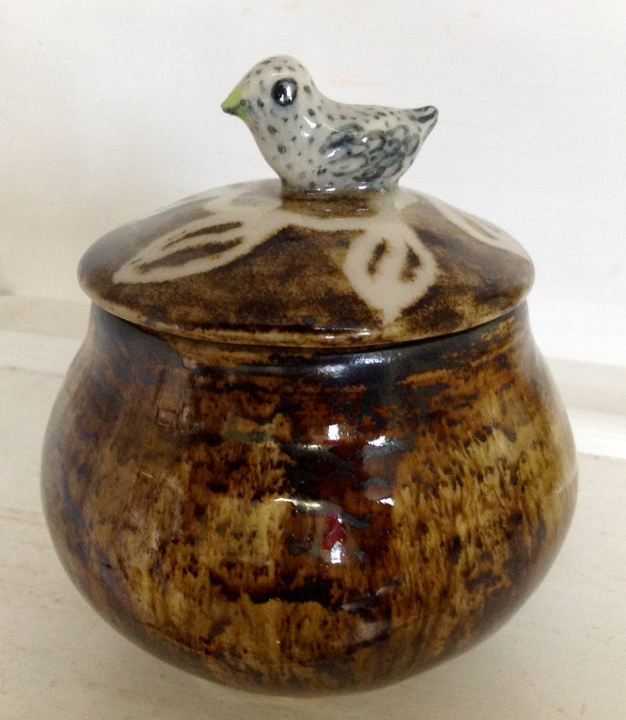 Jar with lid and bird