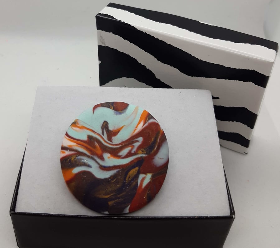 Multicoloured circular polymer clay brooch