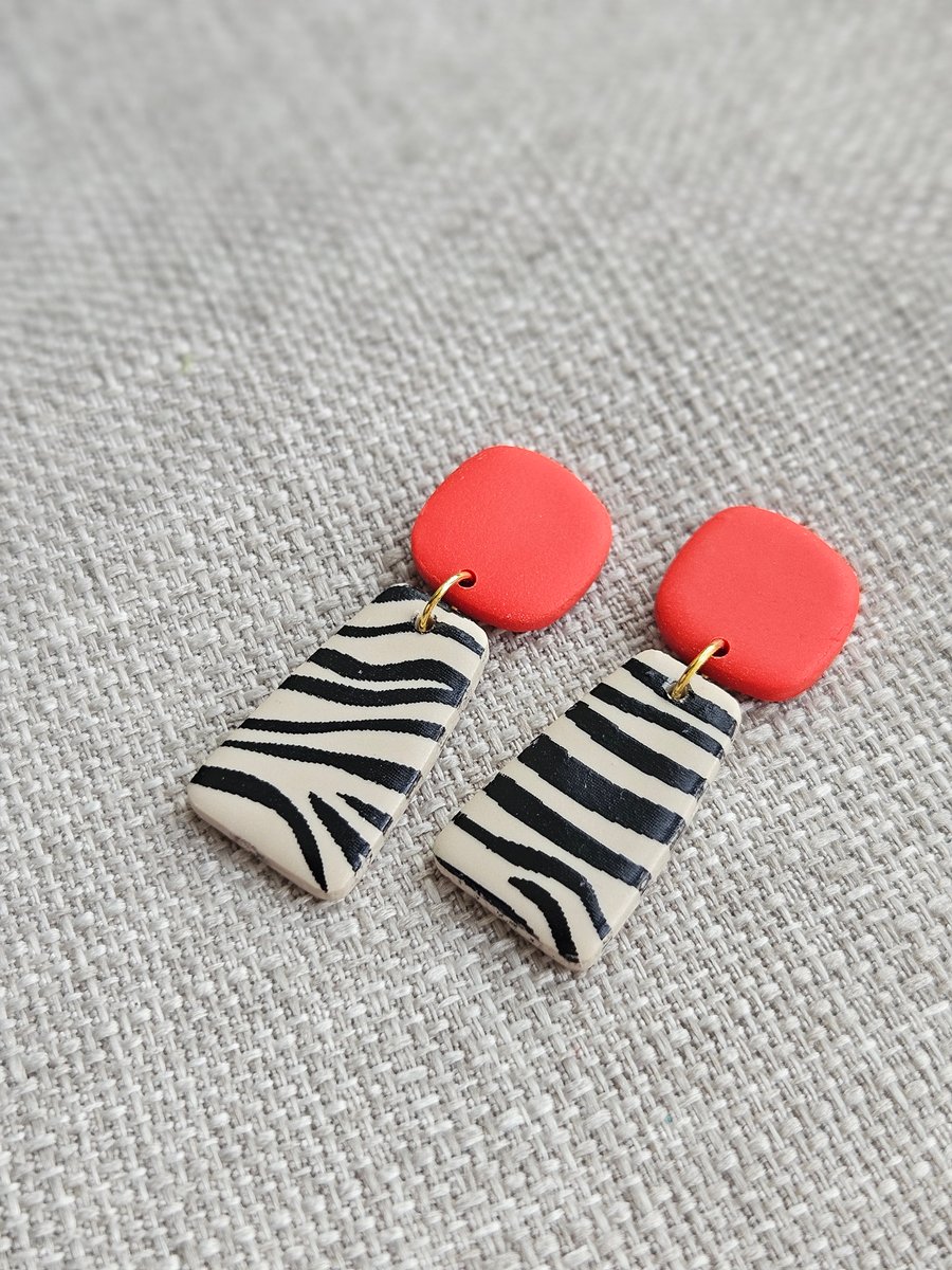 Bright orange animal print dangly earrings