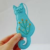 Smiling cat hanger in turquoise felt with embroidered tummy