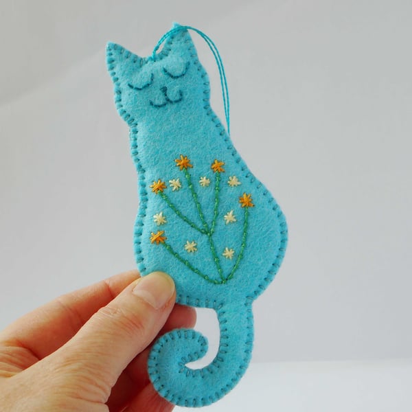 Smiling cat hanger in turquoise felt with embroidered tummy