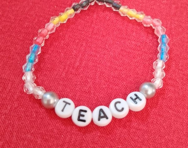 Handmade beaded bracelet with teach in letters.