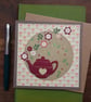 Handmade card, keepsake with dark red teapot and flowers on a tulip background 