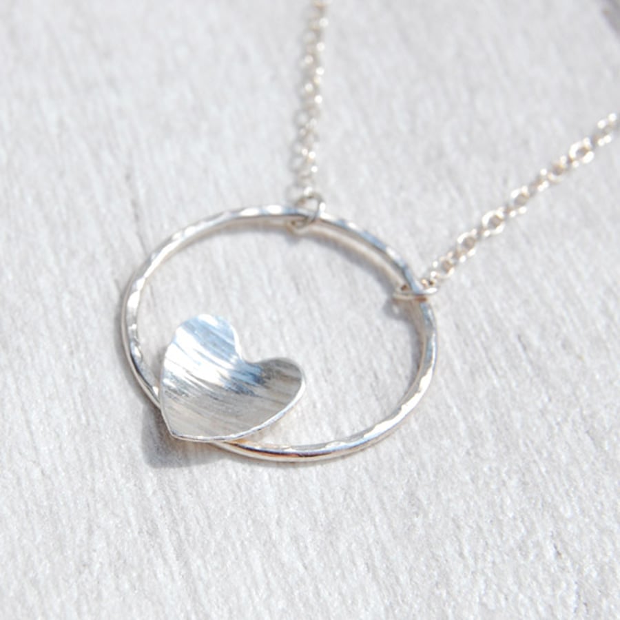 Silver heart and hammered circle necklace