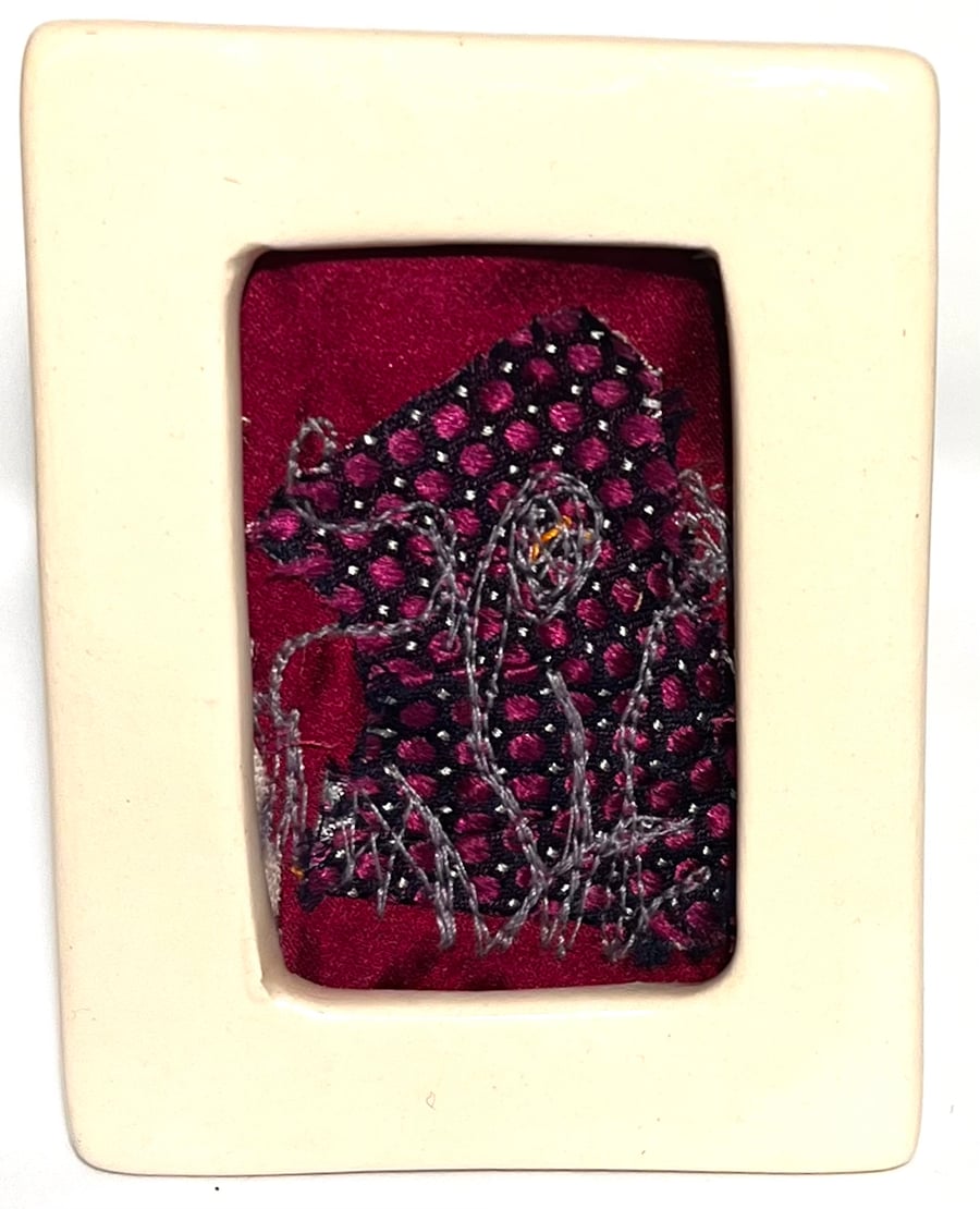 Mini floral free-motion embroidery on layered background in porcelain frame