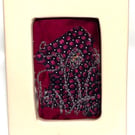 Mini floral free-motion embroidery on layered background in porcelain frame