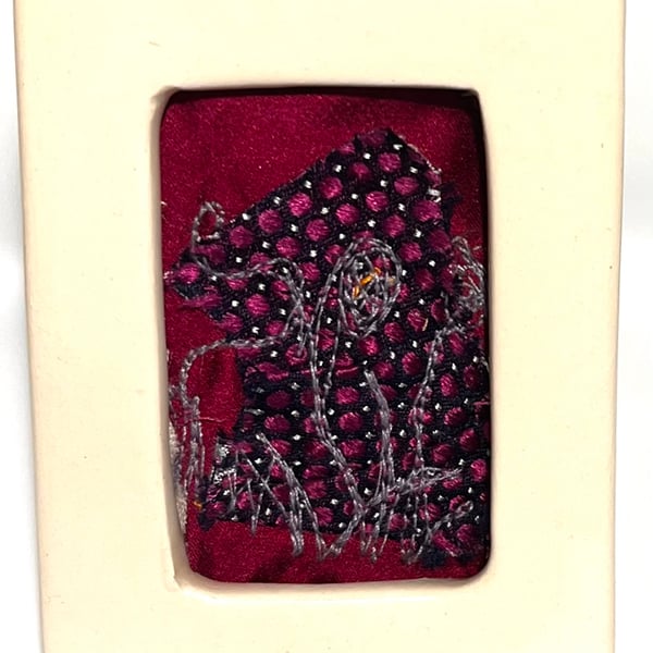 Mini floral free-motion embroidery on layered background in porcelain frame