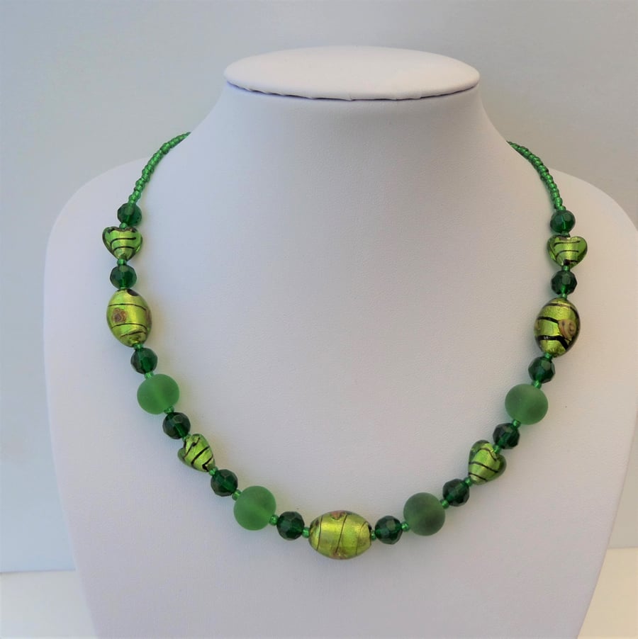 Green oval and heart foiled, round frosted and faceted glass bead necklace.