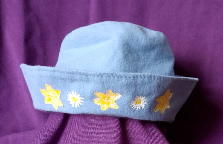 Hat for teens, powder blue with yellow painted flowers.