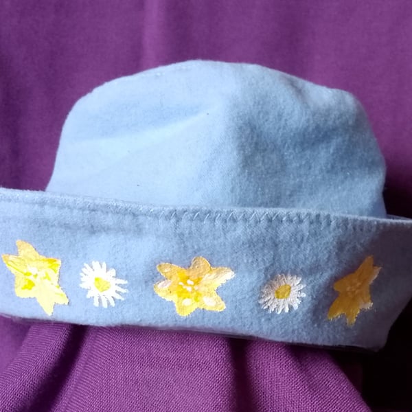 Hat for teens, powder blue with yellow painted flowers.