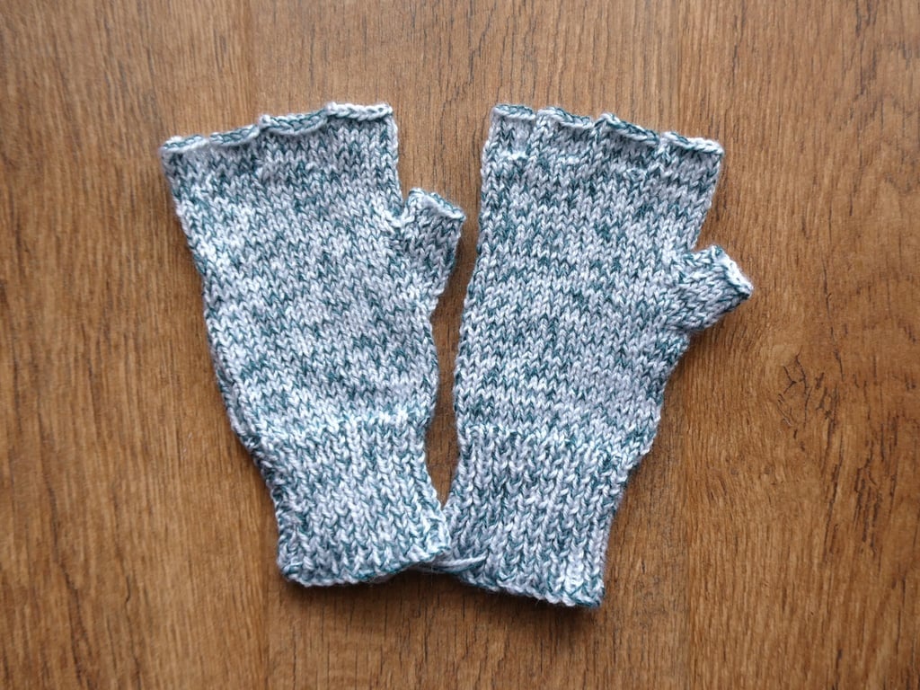 Knitted handmade green and white patterned fingerless gloves