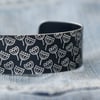 Black aluminium cuff - seed head pattern