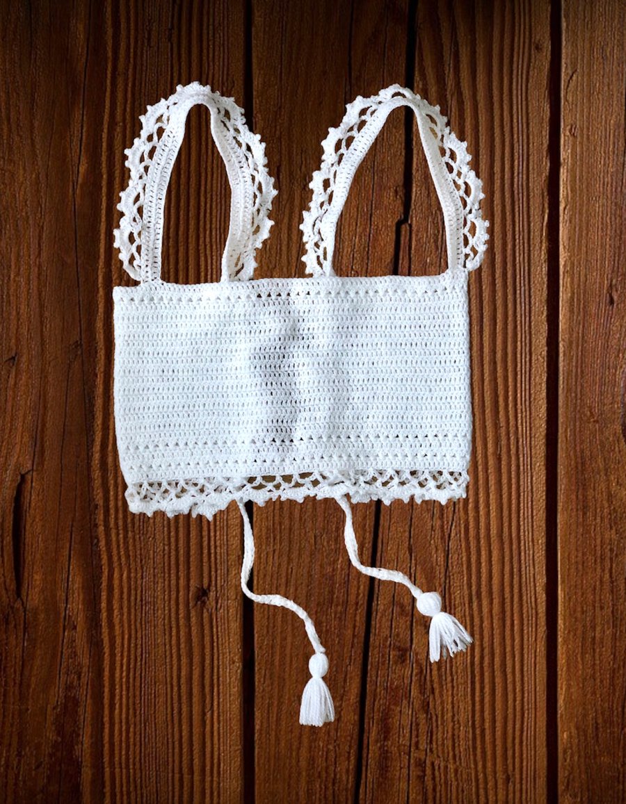 White crochet halter top, with lace like style shoulder straps. U.K. size small.