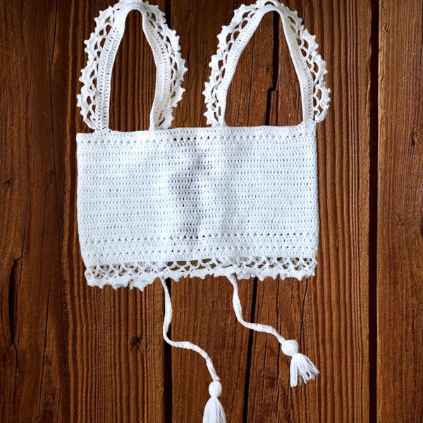 White crochet halter top, with lace like style shoulder straps. U.K. size small.