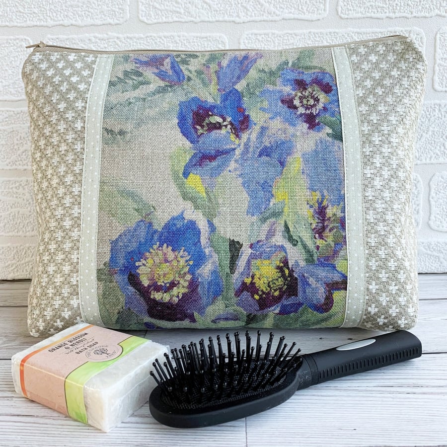 Beige and white toiletry bag with floral panel featuring purple flowers