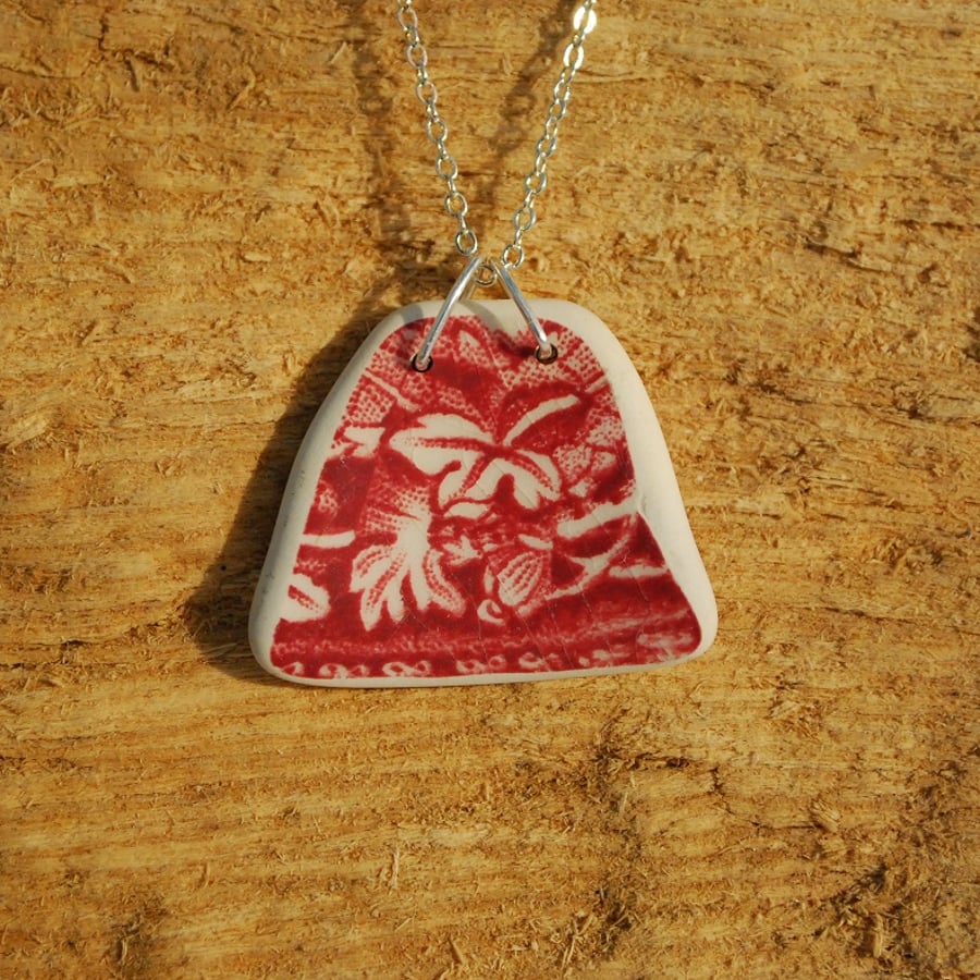 Dark red beach pottery pendant with leaves