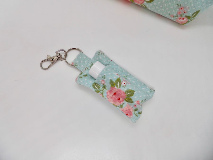 Key ring lip balm holder in blue and pink vintage style print.
