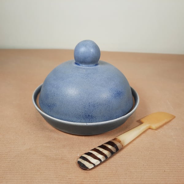 A hand thrown blue ceramic butter dish