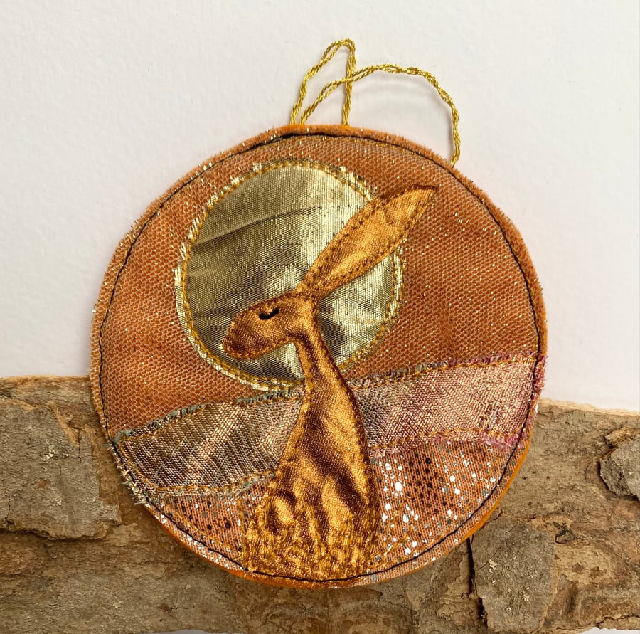 Upcycled embroidered harvest hare home decoration. 