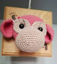 Crocheted monkey trophy head on wooden board