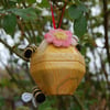 Upcycled beehive shaped tin  decorated with needle felted bees 