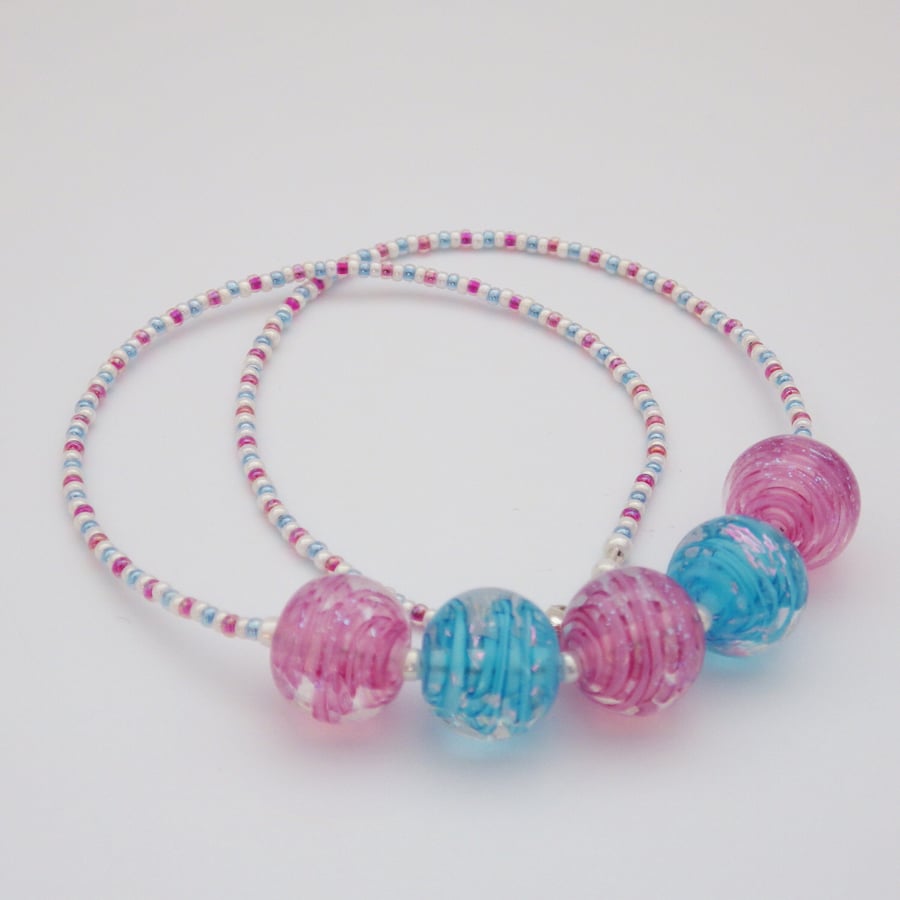 Pink and blue swirling ribbons dichroic lampwork glass bead necklace