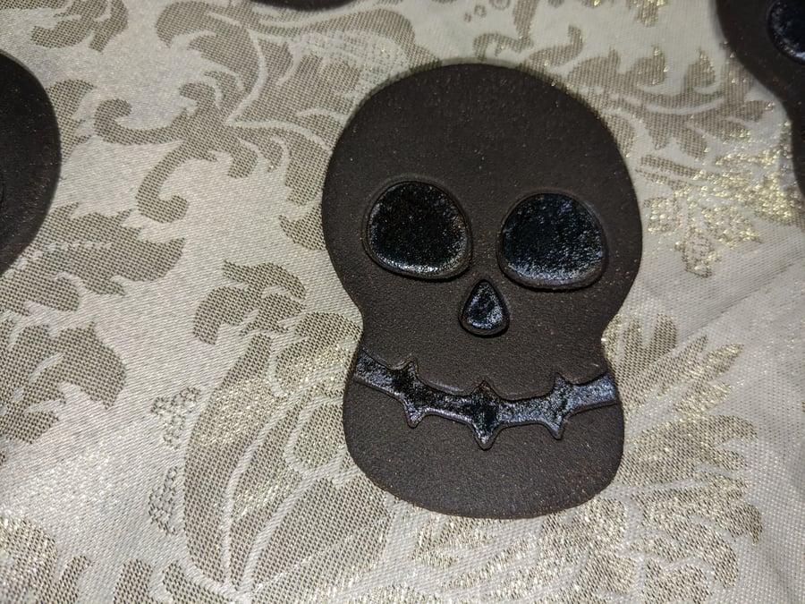 Handmade ceramic black clay skull decoration