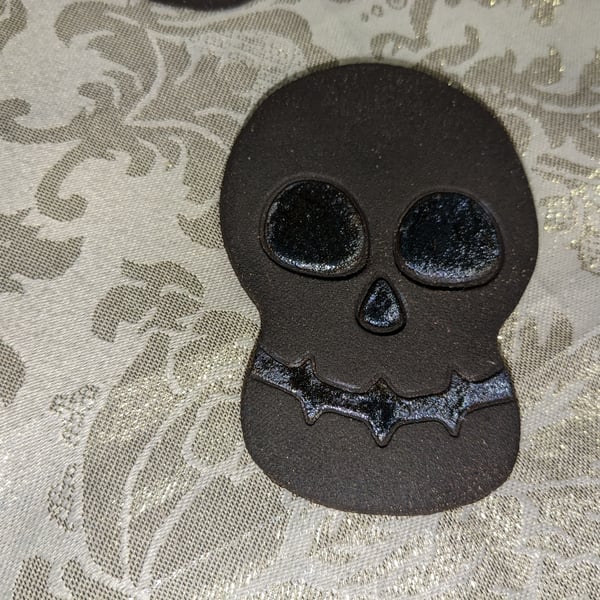 Handmade ceramic black clay skull decoration